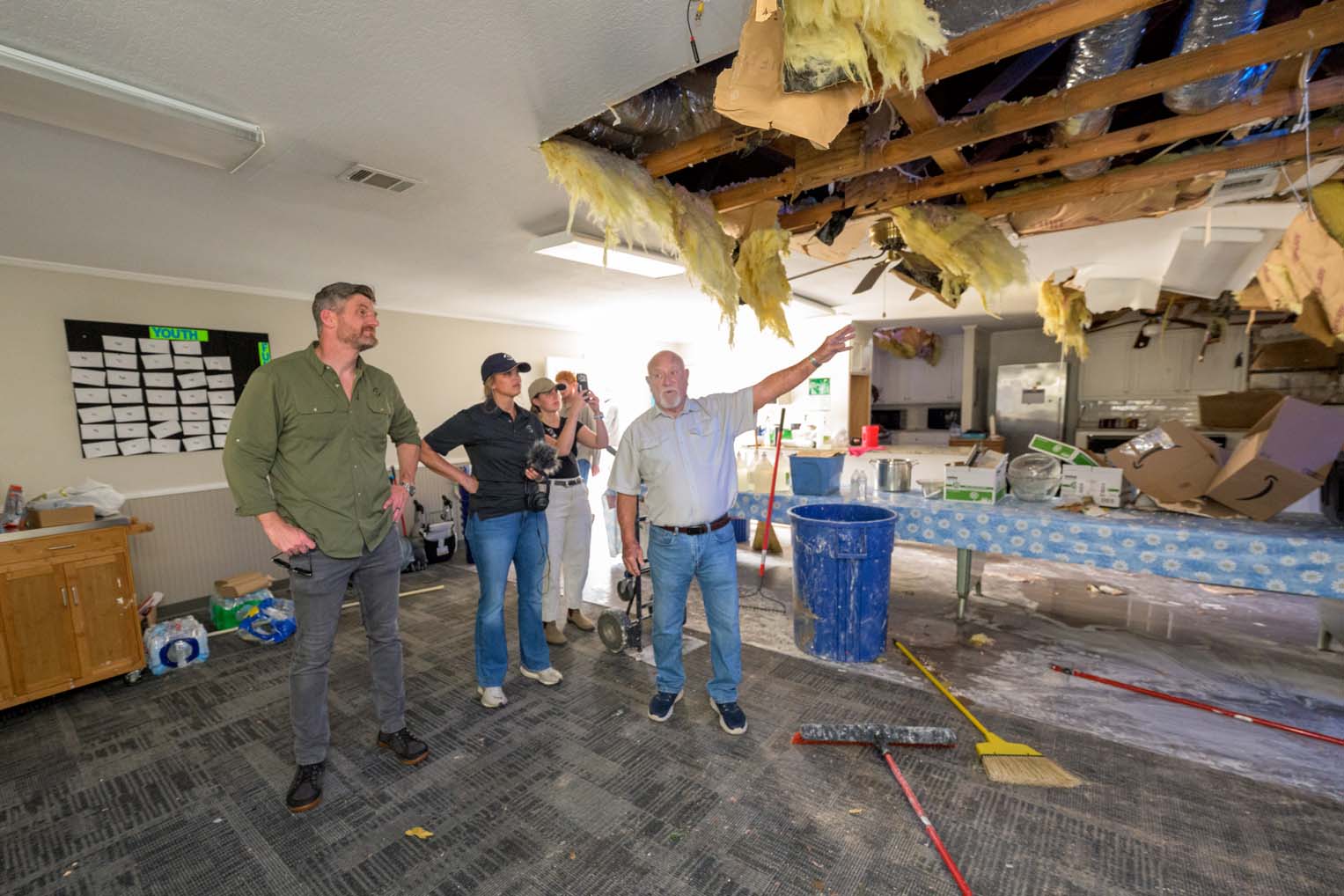 Pastor Jimmy Breazeale shows the Grahams the damage at Coaltown Baptist Church after a tornado tore through during midweek services.