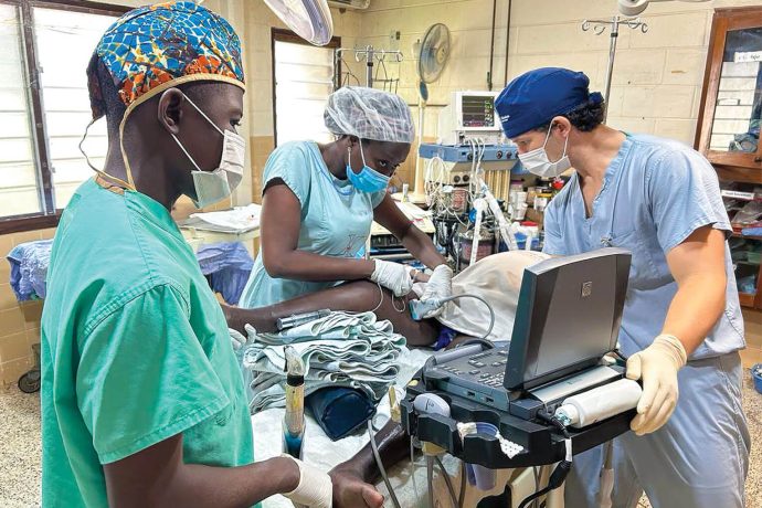 Buchanan and Togolese anesthetists serve a patient on the operating table