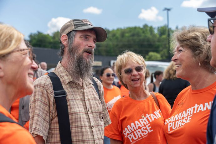 Samaritan's Purse volunteers talk with homeowner Brian Baker