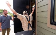 homeowner throws up his hands in delight when Samaritan's Purse foreman opened the door to his new home for the first time