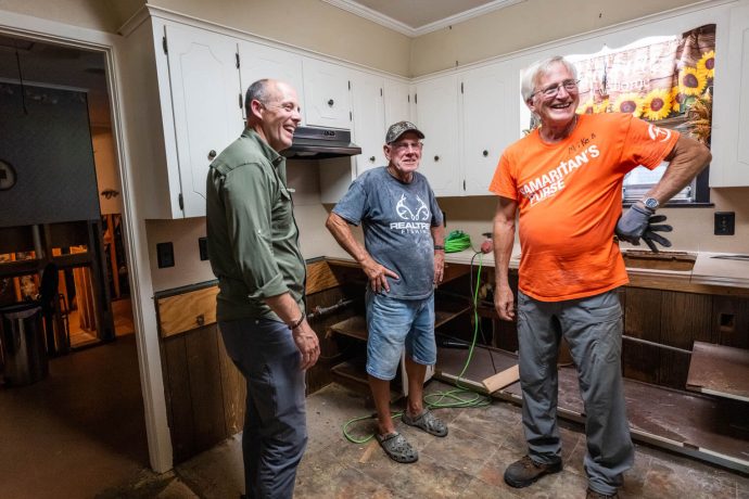 A staff member and volunteer encourage a Louisiana homeowner