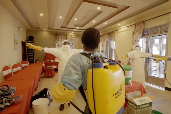 Medical workers practice chlorine disinfection techniques during infection prevention and control training.