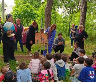 A globe peaks children's interest at an Operation Christmas Child outreach event outside Tbilisi, Georgia