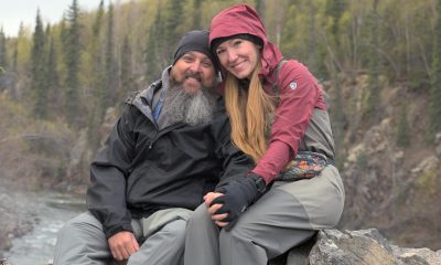 A married couple rests on a rock outcropping at Tanalian Falls near Samaritan Lodge Alaska during Operation Heal Our Patriots.