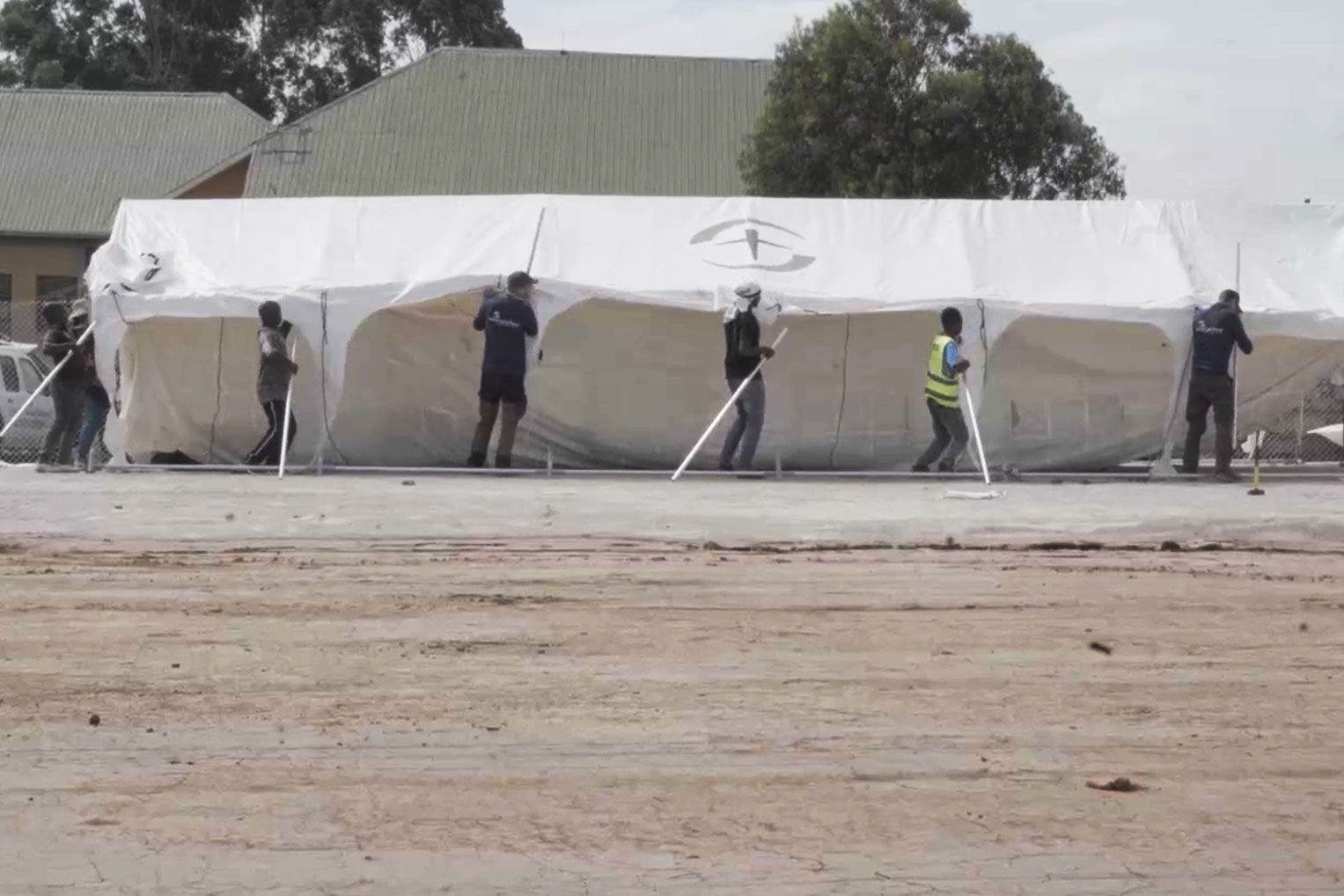 Workers raise a structure at one of our Ebola Treatment Centers under construction in Ituri Province.