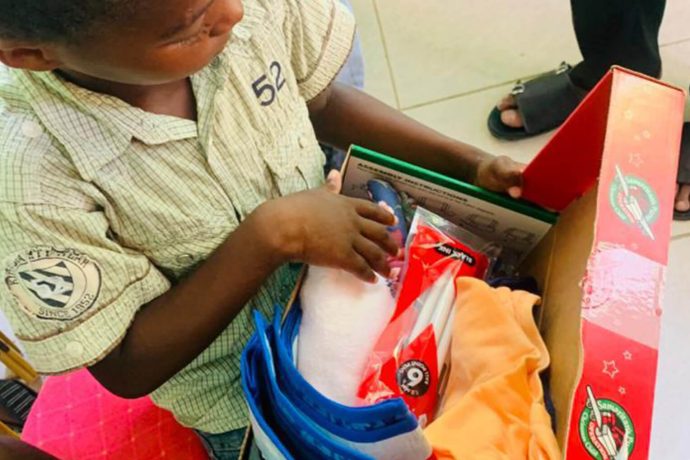 aerial view of boy unpacking a shoebox gift