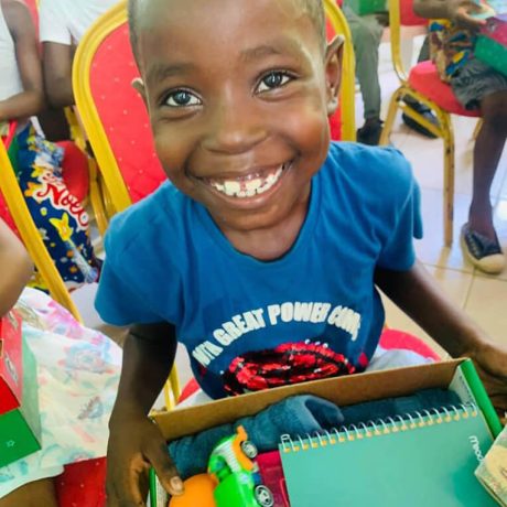 boy in Gabon smiles with his shoebox gift