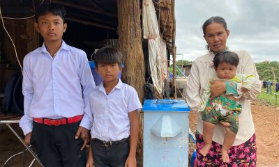 Sovandy's family pose with their water filter from Samaritan's Purse