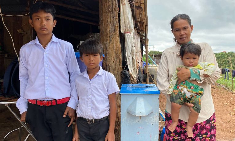 Sovandy's family pose with their water filter from Samaritan's Purse