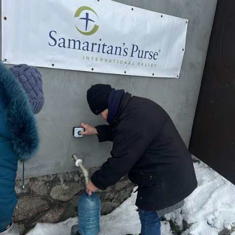 Kateryna fills her water bottle