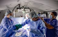 The Emergency Field Hospital surgical team assists Dr. Warren Cooper in preparation for one of many emergency procedures treating Venezuelan earthquake survivors.