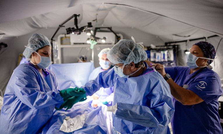 The Emergency Field Hospital surgical team assists Dr. Warren Cooper in preparation for one of many emergency procedures treating Venezuelan earthquake survivors.