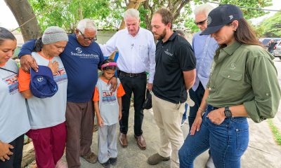 Franklin Graham, joined by daughter, Cissie Graham Lynch and Samaritan's Purse board member Melvin Graham, pray with Pastor Eusebio and his family.