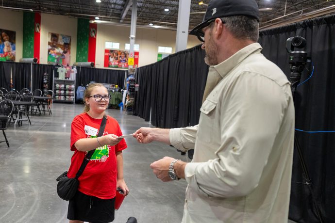 Edward Graham hands Abigail Porter a token of gratitude from Samaritan's Purse