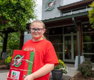 Abigail Porter holds a shoebox she packed in front of the Operation Christmas Child offices in Boone, North Carolina