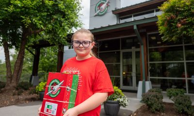 Abigail Porter holds a shoebox she packed in front of the Operation Christmas Child offices in Boone, North Carolina