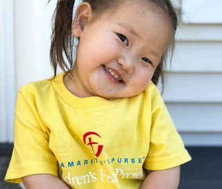 Mongolian girl smiles while turning her head to one side