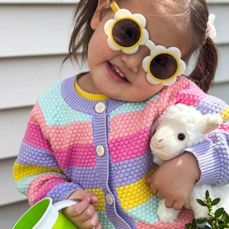 Bayarchimeg in sunglasses, holding a stuffed lamb