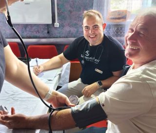 Mobile Medical Unit staff take the blood pressure of Mykhailo