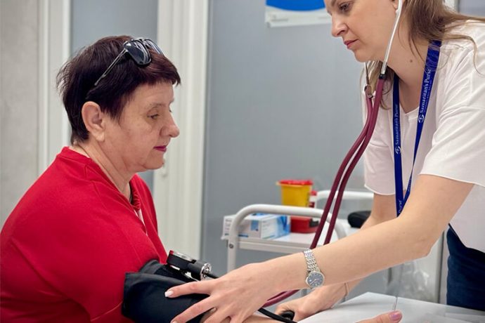 Nurse checks Nadia's blood pressure