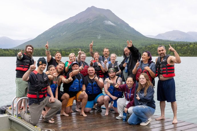 In the weekly "Polar Plunge" tradition at Samaritan Lodge Alaska, military couples brave the cold and jump of the dock into the lake.