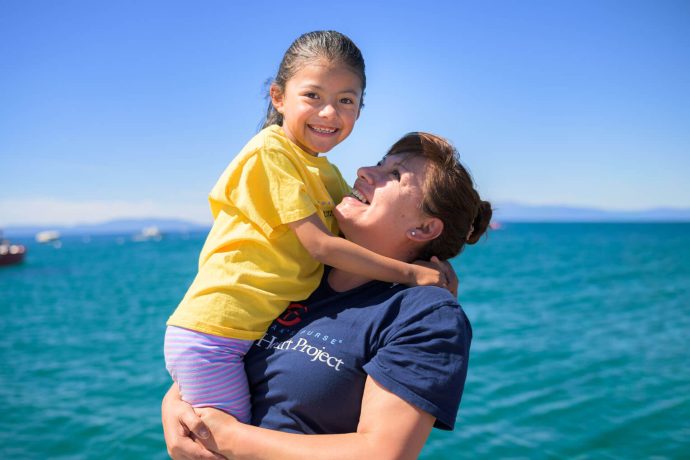 Judi holds Dara at a lakeside