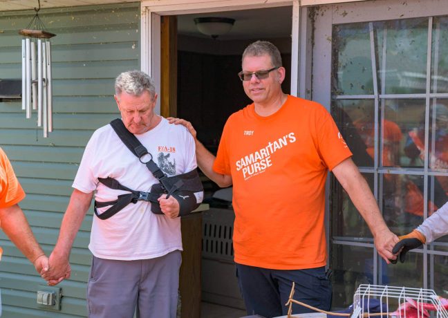 Volunteer Troy prays for homeowner Mike