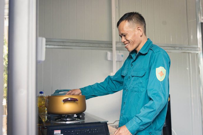 Cham tends to a cooking pot