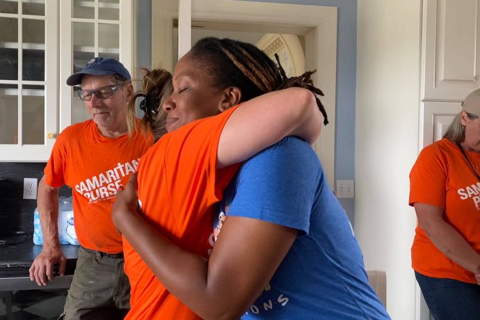 Volunteer hugs Khadija