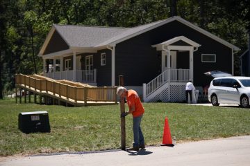 A volunteer puts the final touches on the Mosses new home.