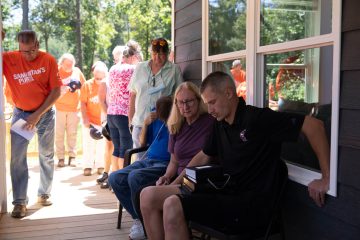 SAMARITAN'S PURSE STAFF AND VOLUNTEERS PRAYED WITH MARY, TOMMY, AND DALLAS OVER THEIR NEW HOME.