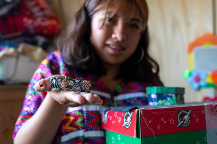 Angelita shows her bracelet from her shoebox gift