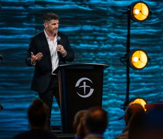 Edward Graham, Chief Operation Officer at Samaritan's Purse, speaks from the stage at the Renaissance Sea World hotel in Orlando.