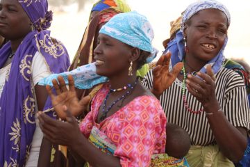 Women in the village welcome our team.